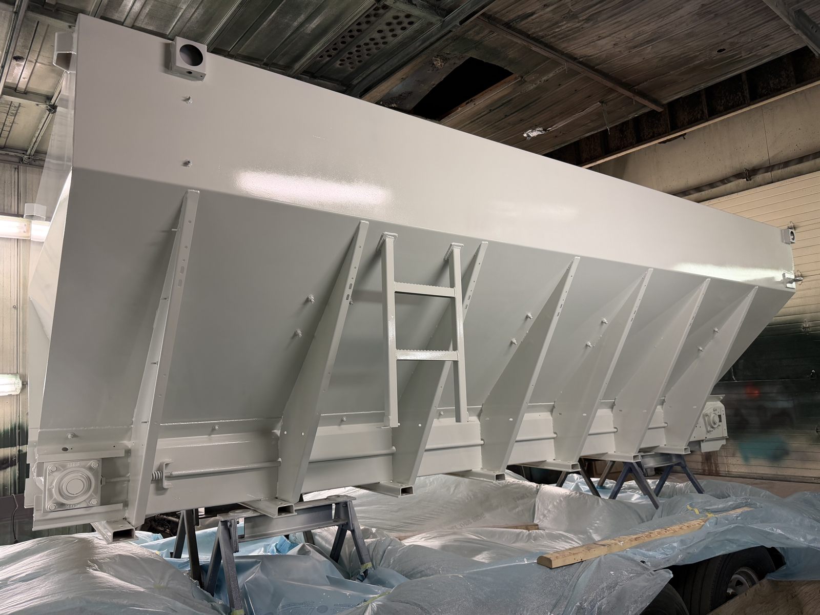 Sander/spreader body in primer during fabrication